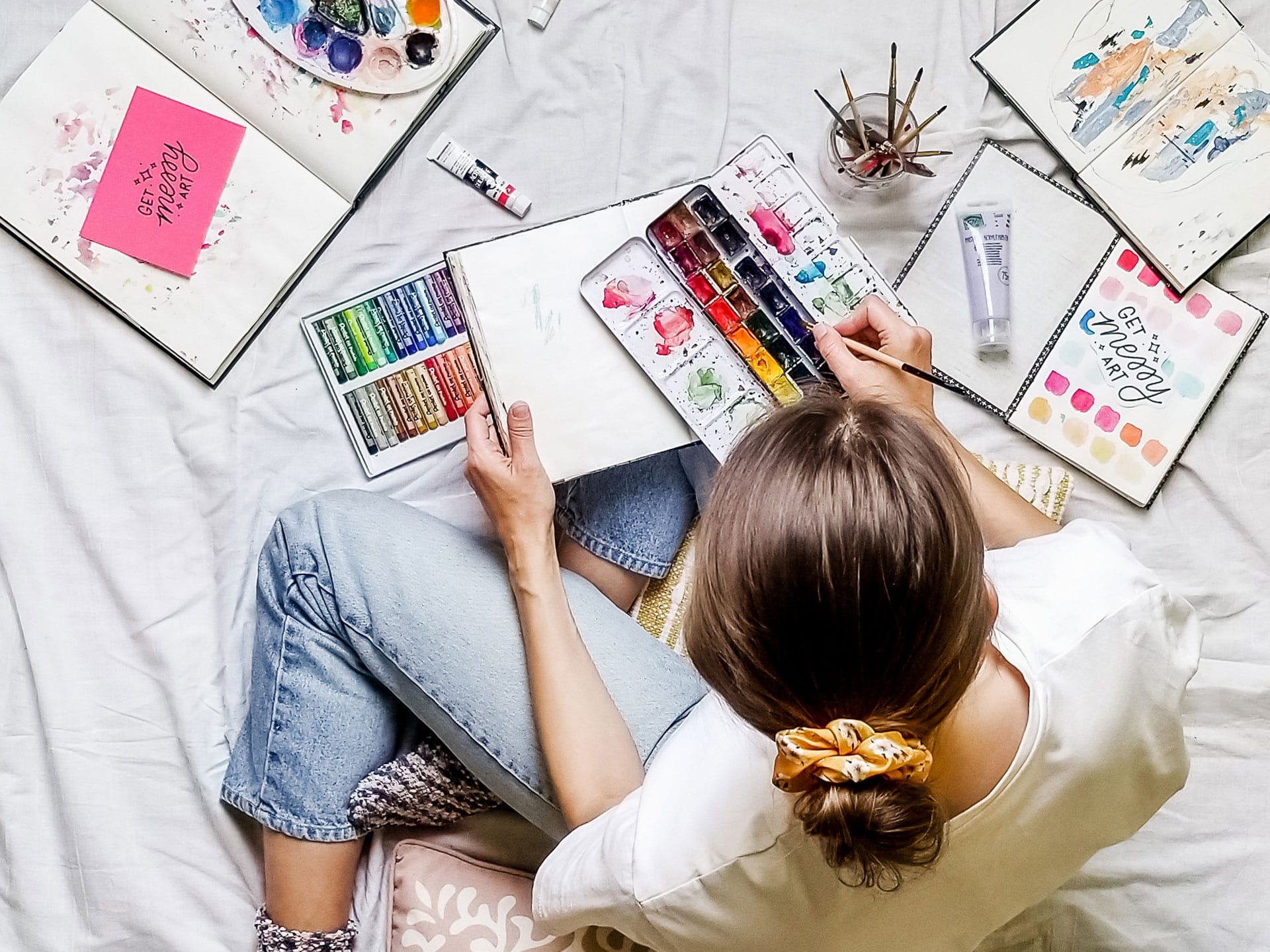 Messy Artist creating in her journals with watercolour